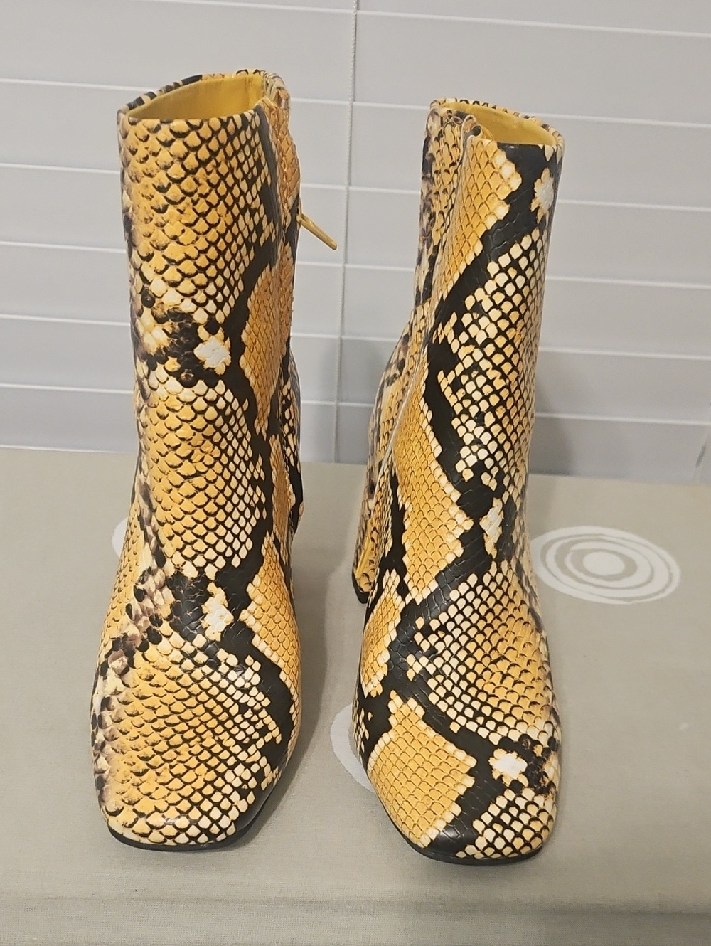 Sugar Yellow and Black Snake-Print Heeled Ankle Boots